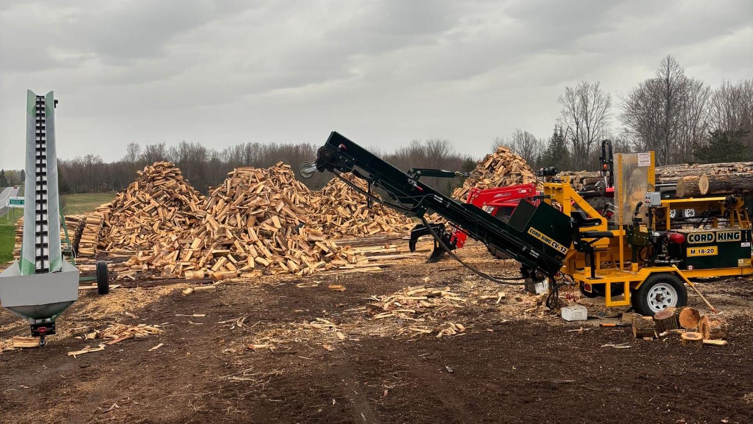 The Cummings Firewood yard in Lanark with the processor and piles of split hardwood